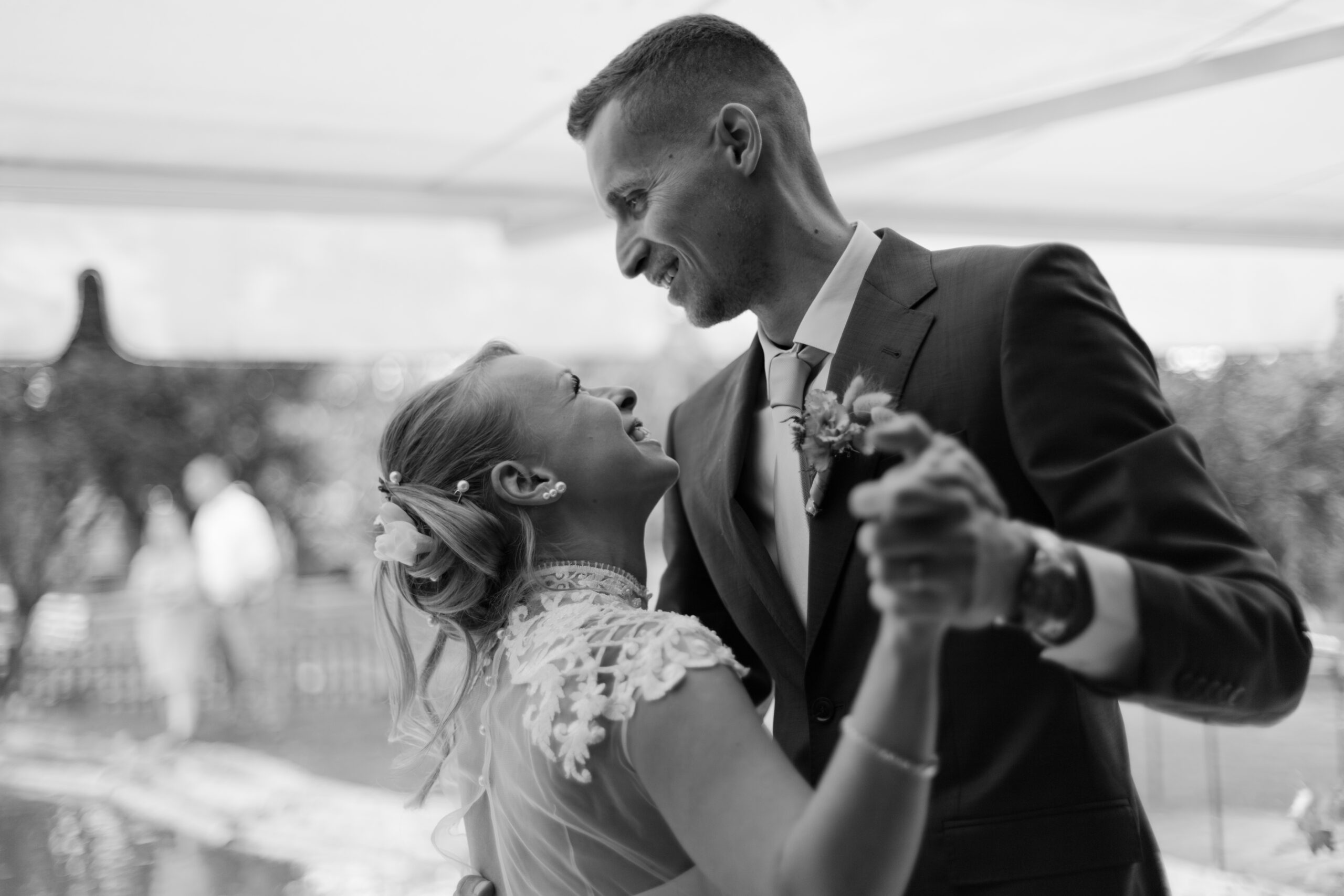 Black and white photo of bride and groom during their first dance lovingly gazing at each other